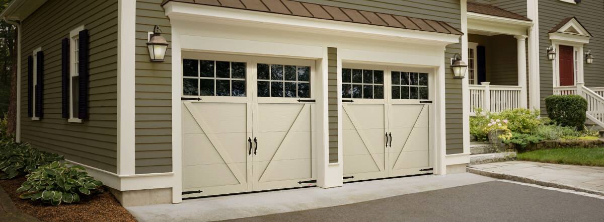 Carriage house style garage doors Princeton model in cream color with Panoramic large glass by Garaga
