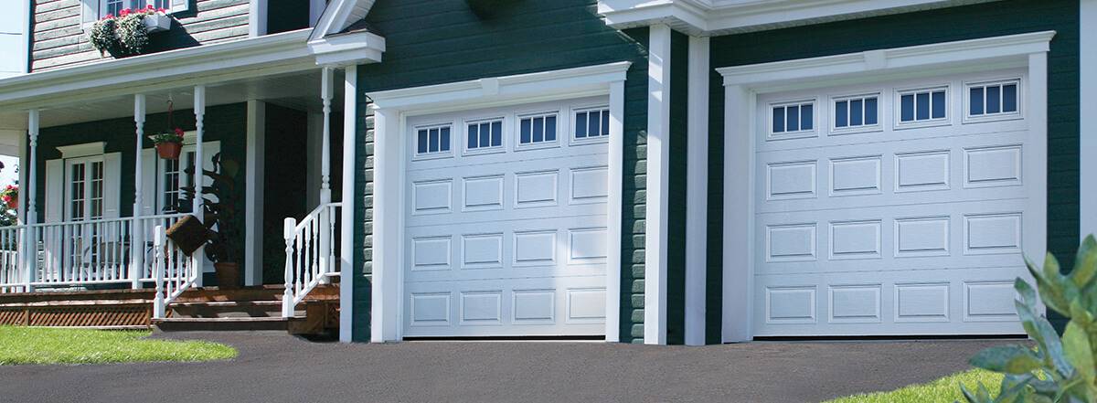 Traditional garage doors Classic CC model in white with windows on top with Richmond insert by Garaga