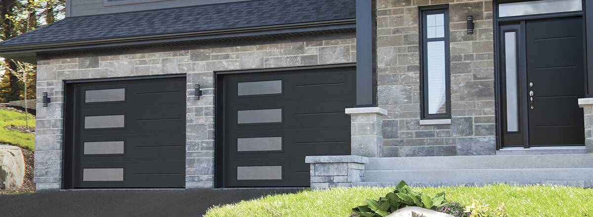 Contemporary modern garage doors Vog model in black with Harmony windows in the side by Garaga